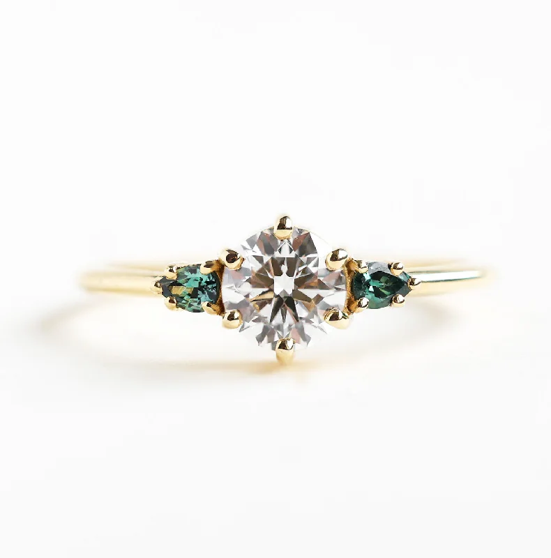 Rings with spiral designs for eye-catching twist -Round Three Stone Diamond Ring With Teal Pear Sapphires